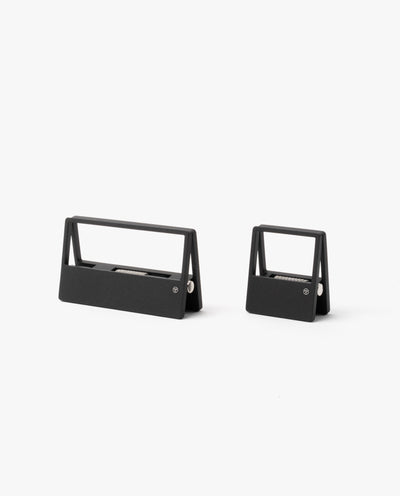 Two modern, minimalist black staple removers in different sizes sit side by side on a plain white background—a sleek addition to any desk organizer paired with your HMM Clips (Set of 2 - Black).