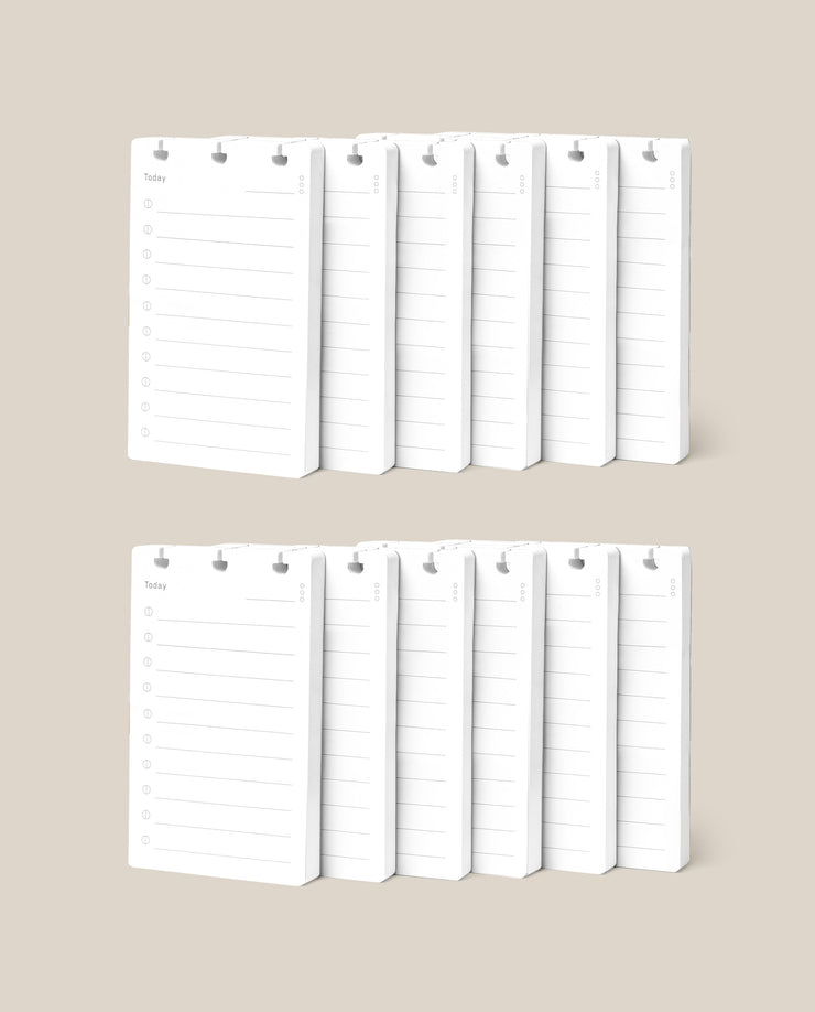 Two rows of white Discbound Analog Refill (12-pack) notepads with checklist designs and checkboxes are neatly arranged against a beige background—ideal for use with Analog Cards or as refills for your Discbound Analog system.
