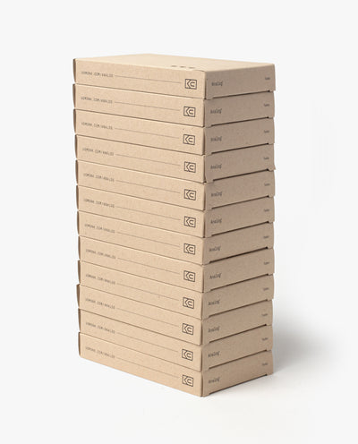 A neatly stacked column of identical brown boxes labeled “Analog Today Cards (12-Pack)” stands against a white background. Each box has a small spine logo and is designed for storing analog note cards or 3x5 cards.