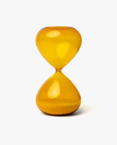 The 25 Minute Hourglass (Amber) is a hand-blown glass timer with amber sand, standing upright on a plain white background—ideal for precise 25-minute Pomodoro sessions.