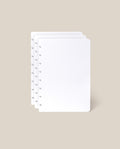 Three stacked sheets from the Discbound Journal Refill (Standard 6" x 8.5" – 3-Pack), featuring a white dot grid and circular holes along the left edge, displayed on a light beige background—ideal for discbound notebooks.