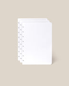 Three stacked sheets from the Discbound Journal Refill (Standard 6" x 8.5" – 3-Pack), featuring a white dot grid and circular holes along the left edge, displayed on a light beige background—ideal for discbound notebooks.