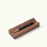 A black Ugmonk Pen (Leuchtturm1917 Drehgriffel) sits on a rectangular wooden pen tray against a plain white background. The bottom left corner notes the pen tray is sold separately.