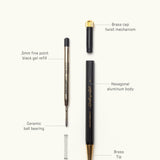 An exploded view of The Ugmonk Pen (Leuchtturm1917 Drehgriffel - Black) shows labeled parts: brass cap, hex aluminum body, brass tip, ceramic ball bearing, spring, and black gel refill—highlighting its elegant design.