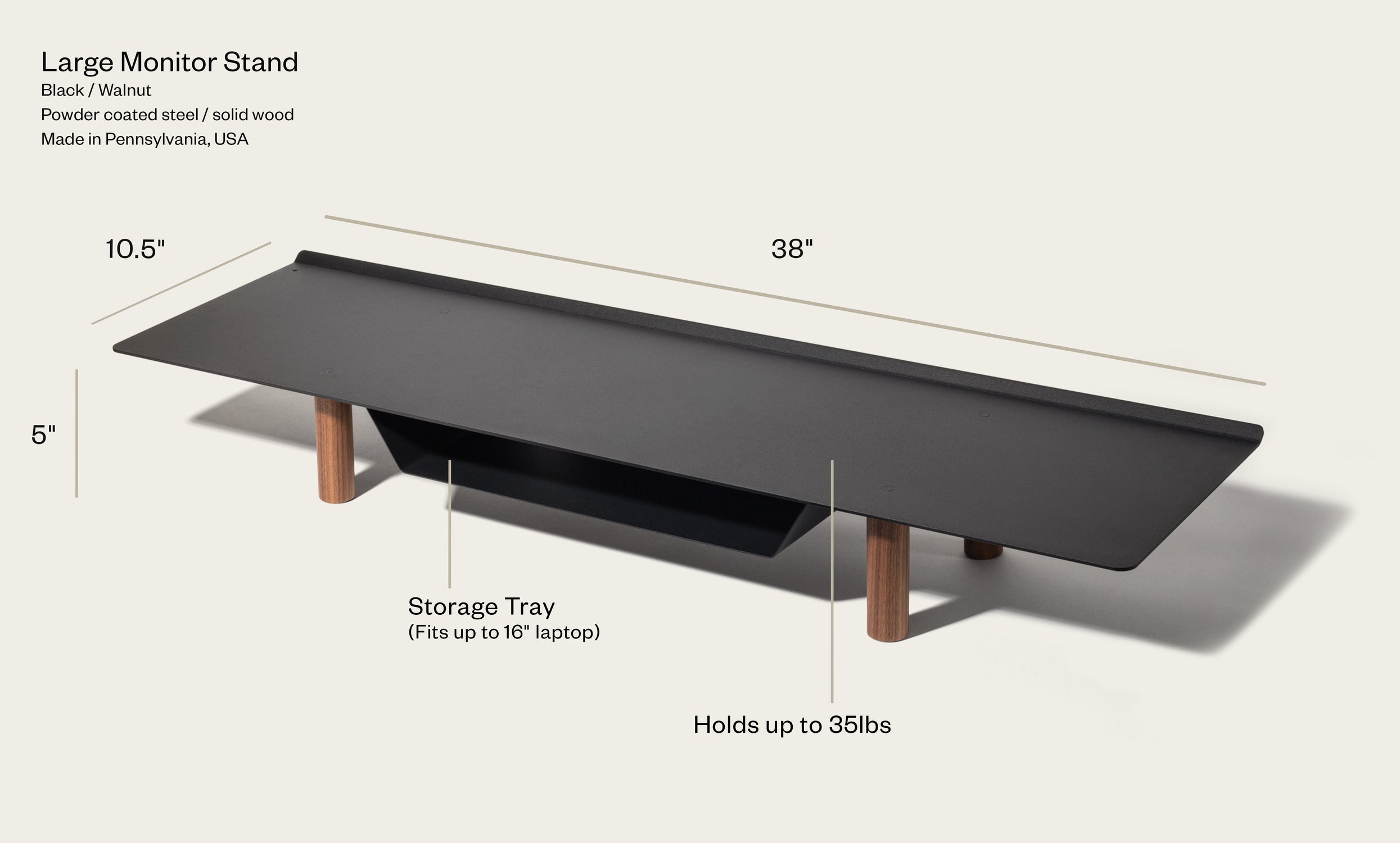 The Gather Large Monitor Stand (Black/Walnut) features solid wood legs, a powder-coated steel surface, a built-in storage tray for up to a 16" laptop, measures 38 x 10.5 x 5", and supports up to 35 lbs.