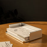 The Complete Analog Collection (Silver Aluminum) rests on a wooden table, holding handwritten notes and sketches in warm sunlight, with extra index cards neatly arranged beside this elegant aluminum organizer.