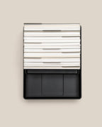 An Analog Archive (Black Aluminum) black metal desk organizer containing a stack of white index cards with dividers.