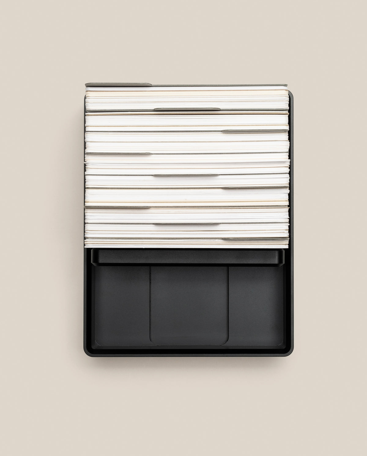An Analog Archive (Black Aluminum) black metal desk organizer containing a stack of white index cards with dividers.