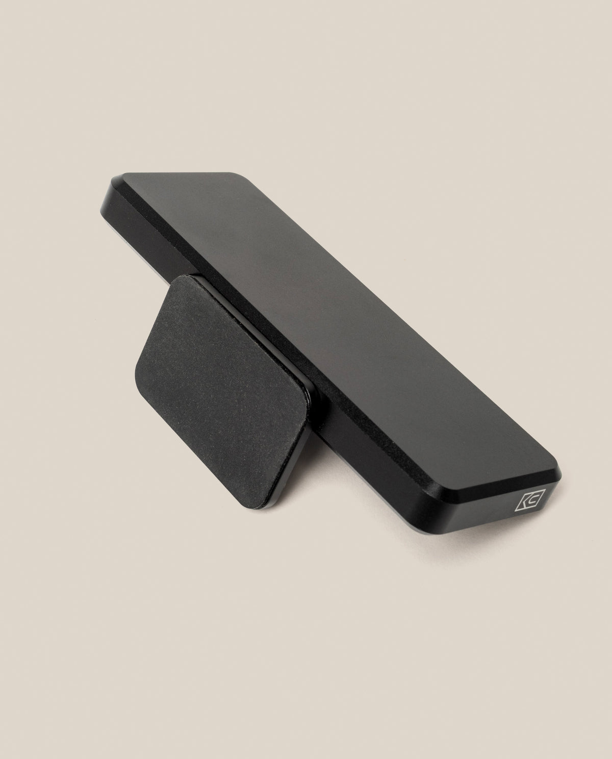 A rectangular black aluminum Analog Archive desk organizer resting on a matching kickstand, with a small logo printed on one corner.