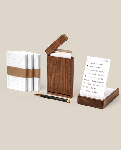 The Analog Bundle (Walnut) features white notecards, a walnut card holder with an open lid, lined notecards, and a refillable pen—all arranged on a neutral background, ideal for your analog kit.