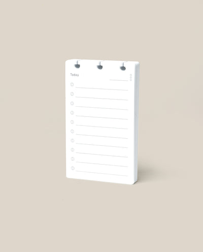 A Discbound Analog Refill (1-Pack), featuring lined pages for daily to-do lists, stands upright on a plain beige background.