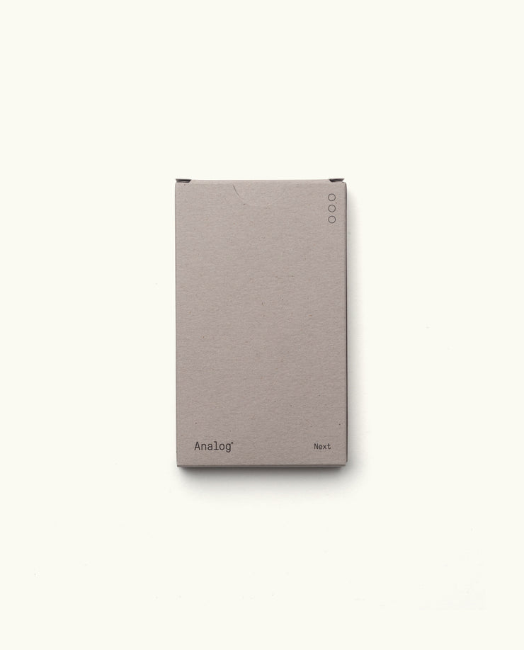 A plain, light gray rectangular box displaying “Analog - Next Cards (1-Pack)” on the bottom front, with three small circular icons in the top right—designed for organizing your dot grid cards for goal setting, shown on a white background.