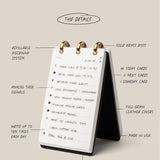 The Leather Discbound Analog (Black) is a compact desktop card organizer with handwritten notes on white cards, brass discs, refillable pages, analog signals, and a stand-up discbound design framed by full-grain leather covers.