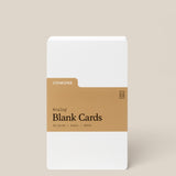 A pack of Analog Blank Cards - Small, made from uncoated cardstock with a brown label reading "Analog Blank Cards, 50 Cards, 3x5in, 100lb," stands upright against a beige background.