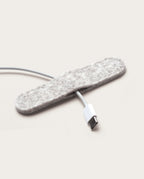 The Warehouse Item - Magnetic Cable Keepers (Set of 2 - Light Gray) are ideal for keeping your USB-C charging cable neatly in place alongside your monitor stand accessories, making them perfect for organizing cables on a light background.