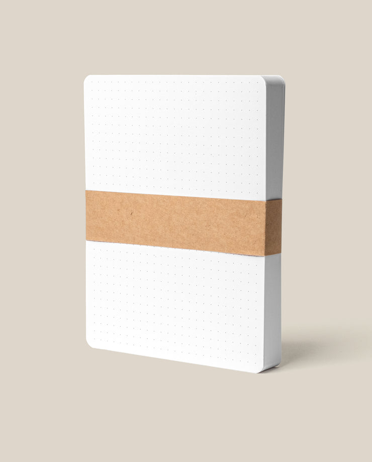 The Analog Dot Grid Cards - Large (1-Pack) features premium white dot grid cards, bound by a brown kraft paper band and shown standing upright against a plain beige background.
