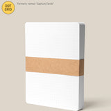 A pack of large (5" x 6.5") Analog Dot Grid Cards—white with rounded corners, held by a brown paper band; ideal for sketching or notes. Previously known as Capture Cards.