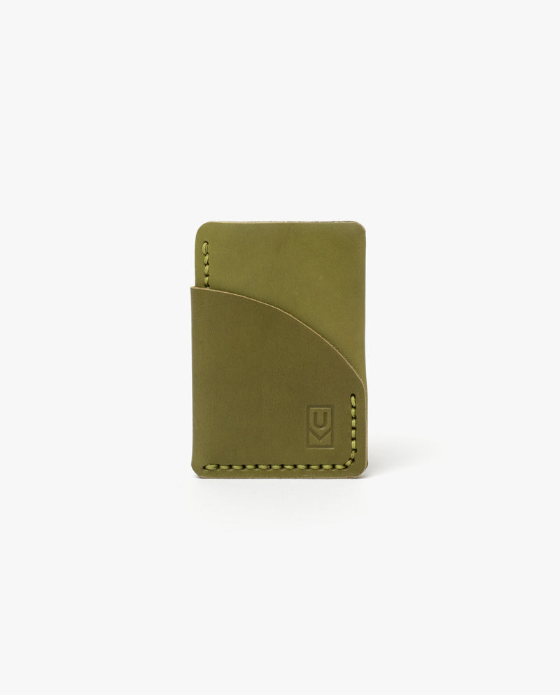A slim, olive green leather card holder with curved stitching and an embossed logo on the front, photographed against a plain white background.