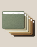 Six Analog Card Sleeves - Large (Earth) in assorted earthy hues are neatly stacked, each elegantly organizing a handwritten index card on lined paper. The sleeves fan out across a beige background, beautifully highlighting their blend of style and practicality for keeping your favorite notes or durable card stock in order.