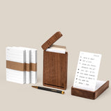 The Analog Bundle (Walnut), featuring note cards, a walnut card holder, a refillable pen, and a handwritten to-do notecard, is elegantly displayed on a beige surface—perfect for upgrading your desk.