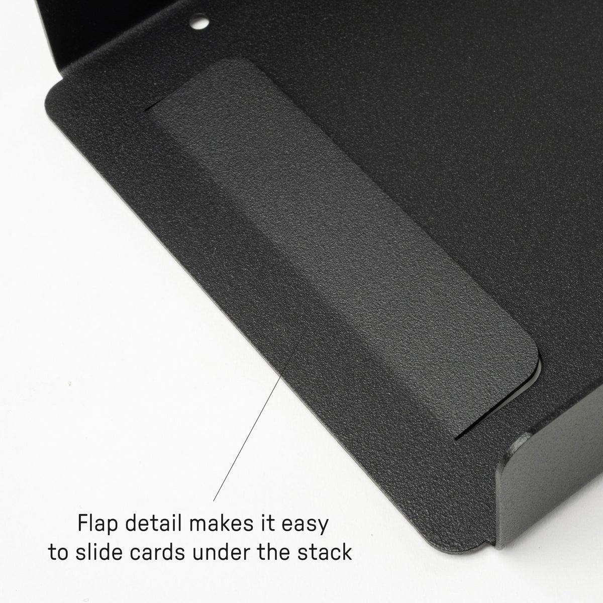 Close-up of a black metal holder with a raised flap detail designed to make it easy to slide cards under the stack. Text on the image reads: Flap detail makes it easy to slide cards under the stack.