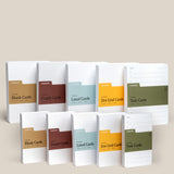 The Analog Card Variety Pack features twelve Ugmonk notepads—blank, graph, lined, dot grid cards—and Task Cards, neatly arranged upright in two rows on a neutral background.