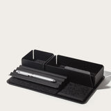 The Gather 2x3 Base Plate (Black) is a minimalist desk organizer made in Pennsylvania with two square compartments, a grooved section for a silver pen, and a felt pad on a rectangular base, shown against a plain white background.