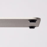Close-up of the corner of a Gather 2x2 Organizer Set (White), showing its powder-coated steel with a textured finish and a round black foot on the underside, set against a plain light background.