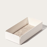 The Gather 2x2 Organizer Set (White) features a minimalist, rectangular design in powder-coated steel with low sides and a light beige felt bottom, shown on a light surface with soft shadows.