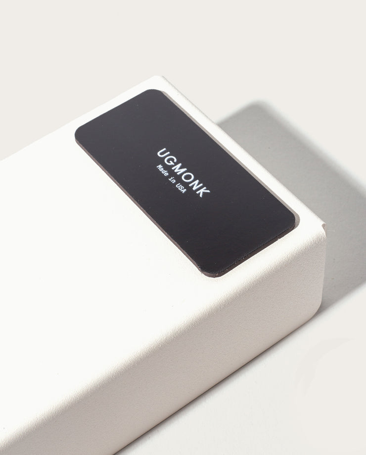 The Gather 2x2 Organizer Set (White) is a minimalist powder-coated steel box with a black label reading "UGMONK Made in USA." This customizable desk organizer casts a subtle shadow on a light surface.