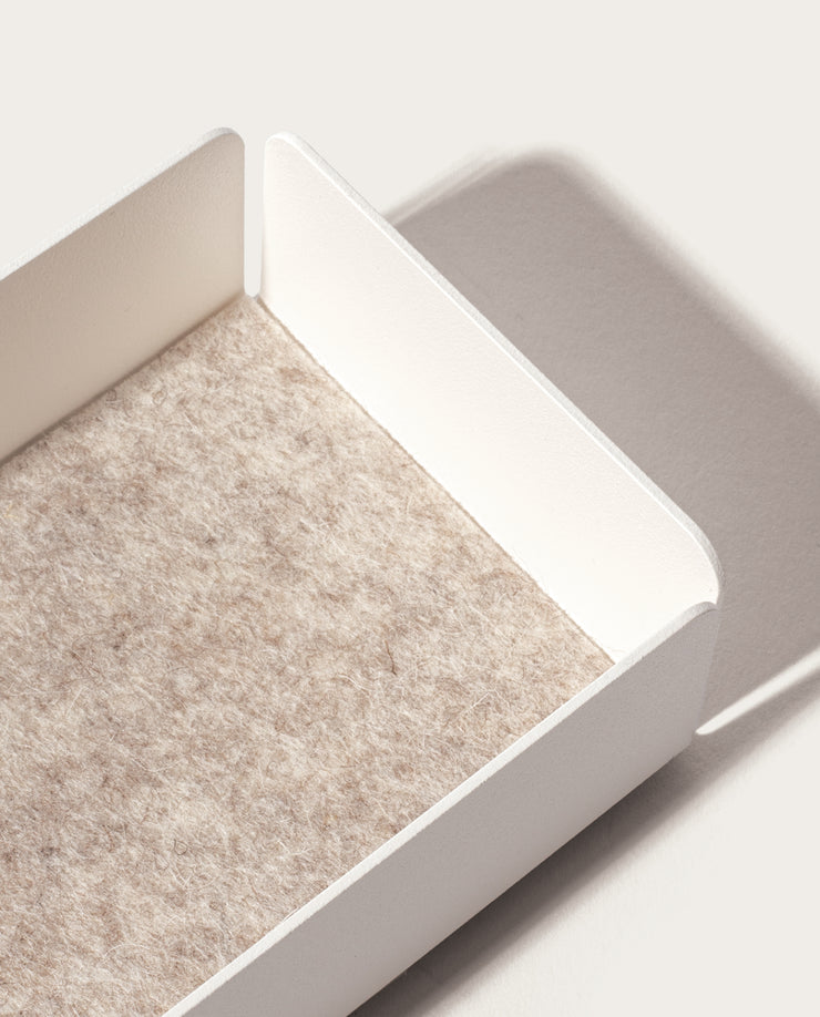 The Gather Medium Tray (2x1 - White) features a minimalistic white powder-coated steel design with raised sides and a beige textured felt base, casting a gentle shadow on a light surface.