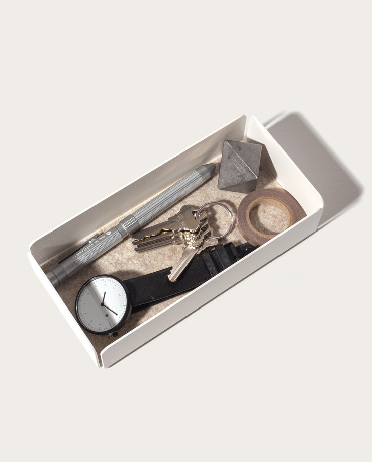 The Gather Medium Tray (2x1 - White), crafted from powder coated steel, offers a stylish and durable way to store your watch and keys.