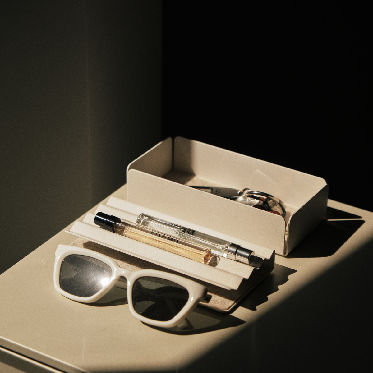 A white sunglasses and pen in a box.