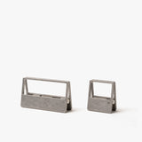The HMM Clips (Set of 2 - Raw) feature sleek, open-frame aluminum designs—one large and one small—resting on a white background. Ideal as modern organizers for your workspace or stylish paper clips.