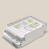 The Analog Capture Kit - 2 Large (Silver Aluminum) holds stacked dot grid cards with hand-drawn website or app wireframes, highlighting sections in green and purple, against a plain light beige background.