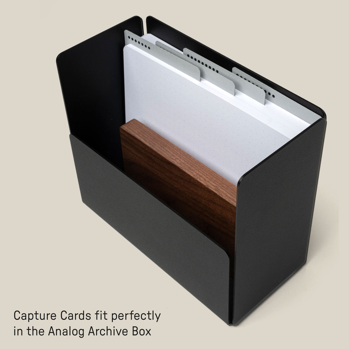 A black rectangular archive box holds white note cards with tab dividers and a wooden divider. Text at the bottom reads, Capture Cards fit perfectly in the Analog Archive Box.