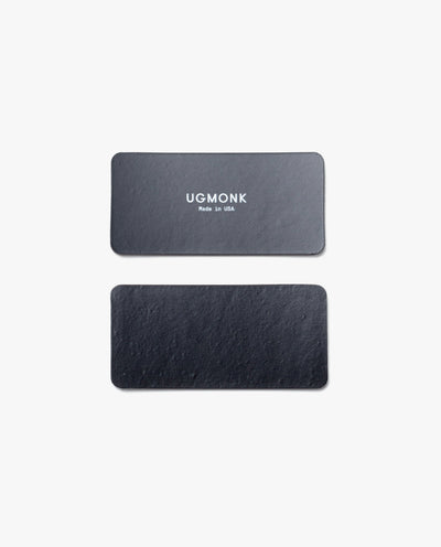 Two black rectangular leather tags for the Magnet Kit (For Analog Card Holder) are shown on a white background. The top tag displays "UGMONK Made in USA" in white, while the bottom tag is plain with no text or markings.