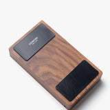The Magnet Kit (For Analog Card Holder) includes two black adhesive magnets with the Ugmonk logo, designed for use on the underside of your rectangular wooden card holder. Featured against a white background.