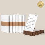 The Analog Daily Focus Kit + 6 Refills (Walnut) is shown with white notepads, brown paper bands, and a walnut card holder displaying a handwritten to-do list. A #1 Best Seller badge appears in the top right corner.