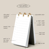 The Discbound Analog is a tabletop flip planner with brass rings, featuring daily task cards with lines and checkboxes, thick card stock, a refillable organizer system, analog productivity focus, and a sturdy stand.