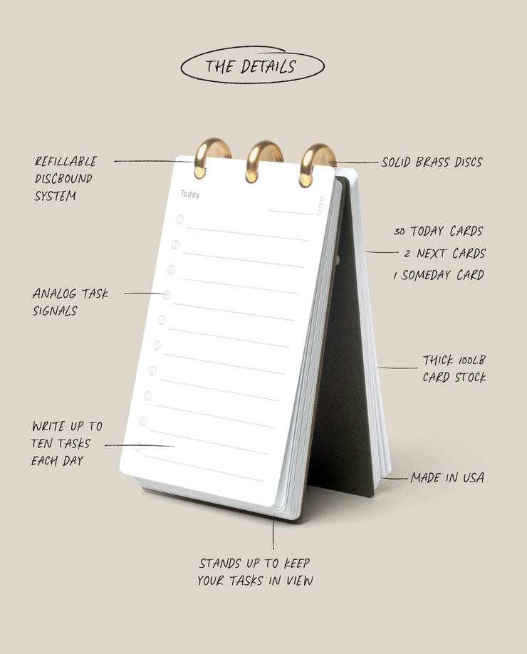 The Discbound Analog is a tabletop flip planner with brass rings, featuring daily task cards with lines and checkboxes, thick card stock, a refillable organizer system, analog productivity focus, and a sturdy stand.