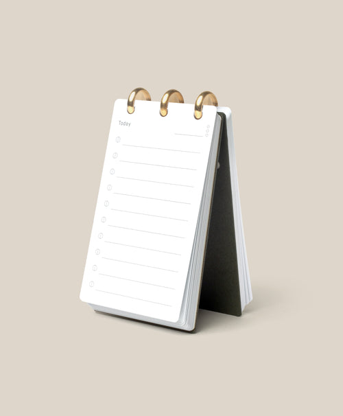 The Discbound Analog, a compact white refillable task organizer, rests open on a beige surface to a fresh “Today” page—ideal for anyone who enjoys working with an analog productivity system.