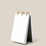 The Discbound Analog, a compact white refillable task organizer, rests open on a beige surface to a fresh “Today” page—ideal for anyone who enjoys working with an analog productivity system.