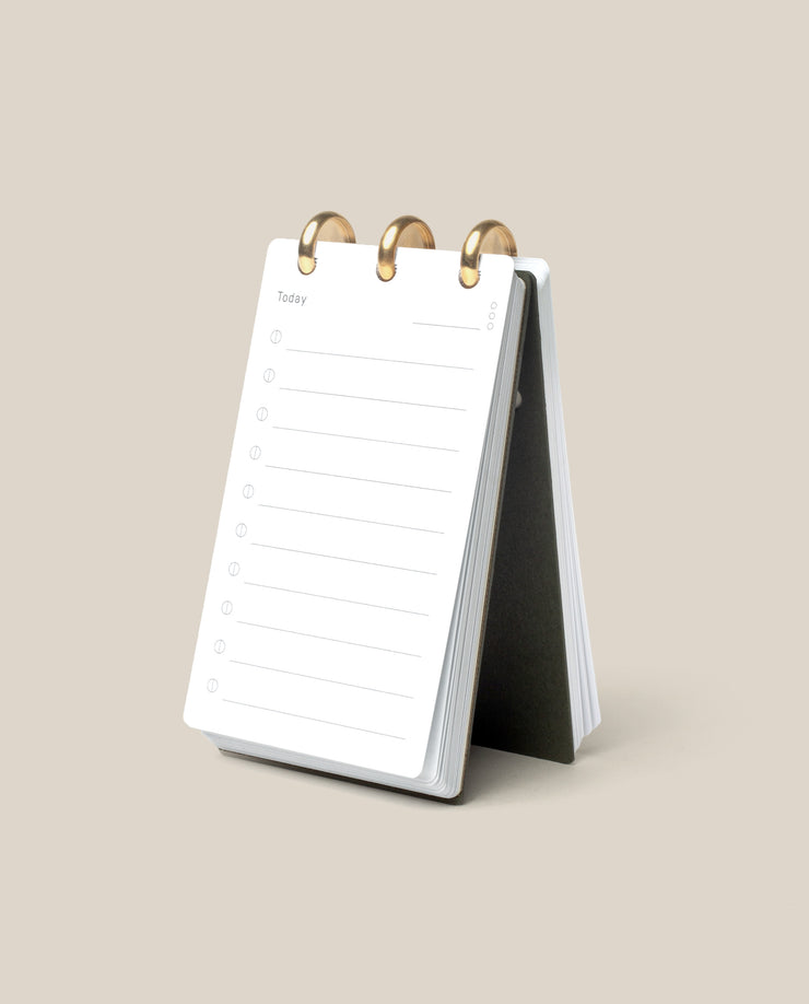 The Discbound Analog, a compact white refillable task organizer, rests open on a beige surface to a fresh “Today” page—ideal for anyone who enjoys working with an analog productivity system.