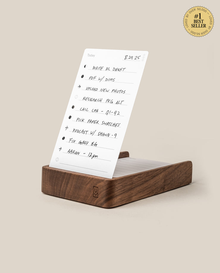 The Analog Daily Focus Kit (Walnut) holds a handwritten to-do list card with bullet-pointed tasks for elegant, analog productivity. A gold #1 Best Seller badge appears in the top right on a beige background.