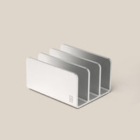 The Analog Card Organizer (Silver Aluminum) features three minimalist slots, ideal for storing cards or organizing mail, files, and devices. Shown on a plain beige surface.