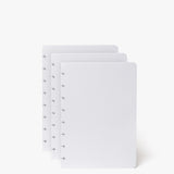 The Discbound Heirloom Journal Bundle includes a black leather 6"x8.5" journal and three white, dotted refill sheets with disc-binding holes—ideal for your refillable notebook or discbound journal.