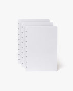 Three sheets of white, dot-grid paper with distinctive notched edges—ideal for the Discbound Heirloom Journal Bundle (Tan Leather – Standard 6" x 8.5" + 3 Refills)—are stacked slightly overlapping on a plain white background.