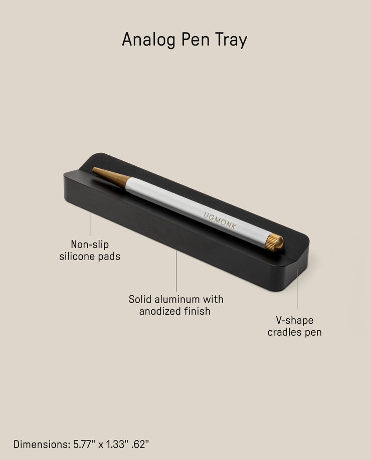 The Analog Pen Tray (Black Aluminum) is a sleek, minimalist desk organizer made from solid anodized aluminum with non-slip silicone pads and a V-shaped cradle. Dimensions: 5.77 x 1.33 x .62 inches—perfect for holding your pen in style.