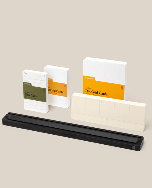 A set of Analog Kit task and dot grid cards in boxes, two stacks of blank Task Cards, and a long black Analog Card Bar - Pro Kit are arranged on a light beige background.